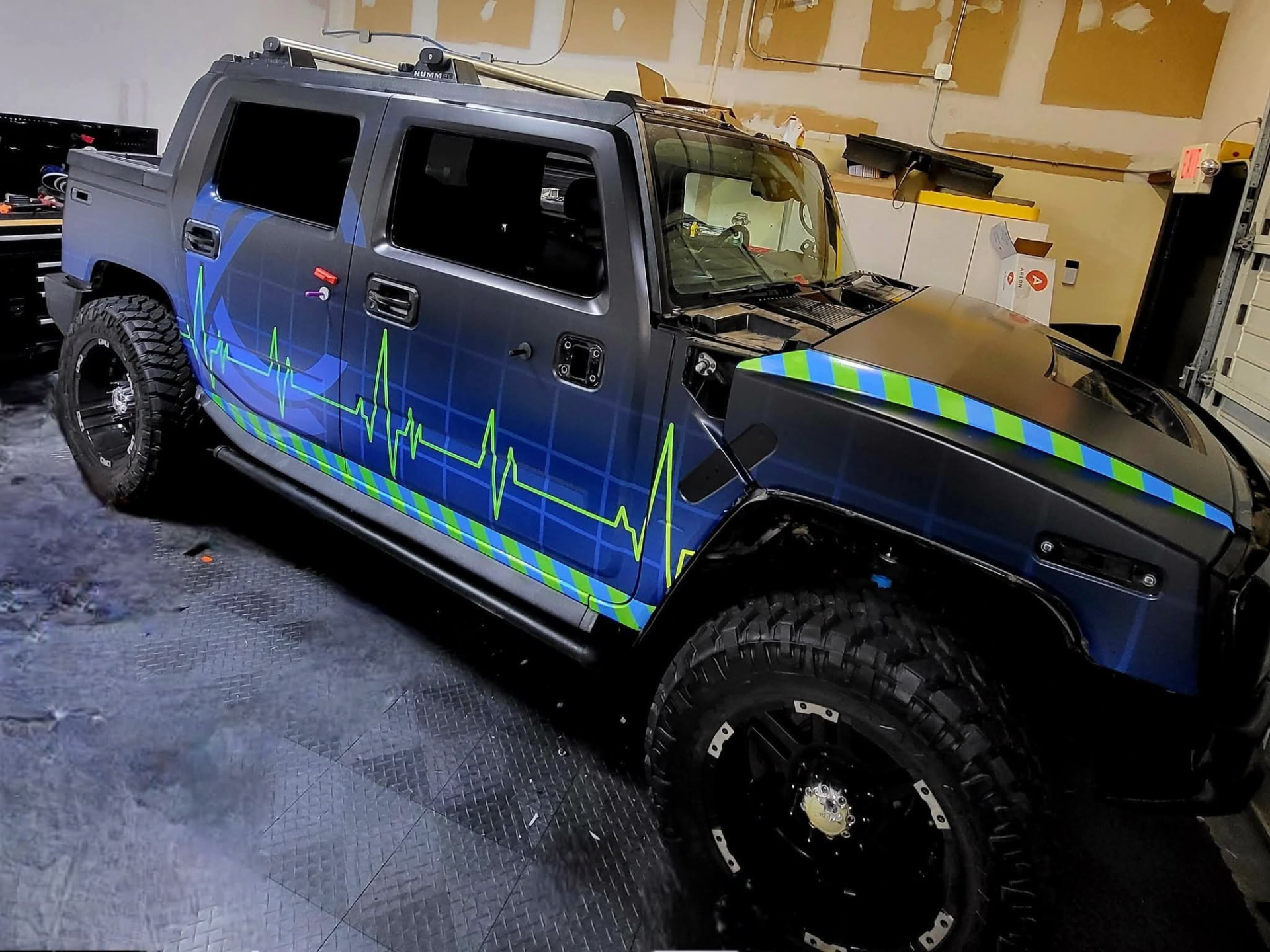 Hummer H2 SUT wrapped in blue with reflective Capstone Imaging graphics