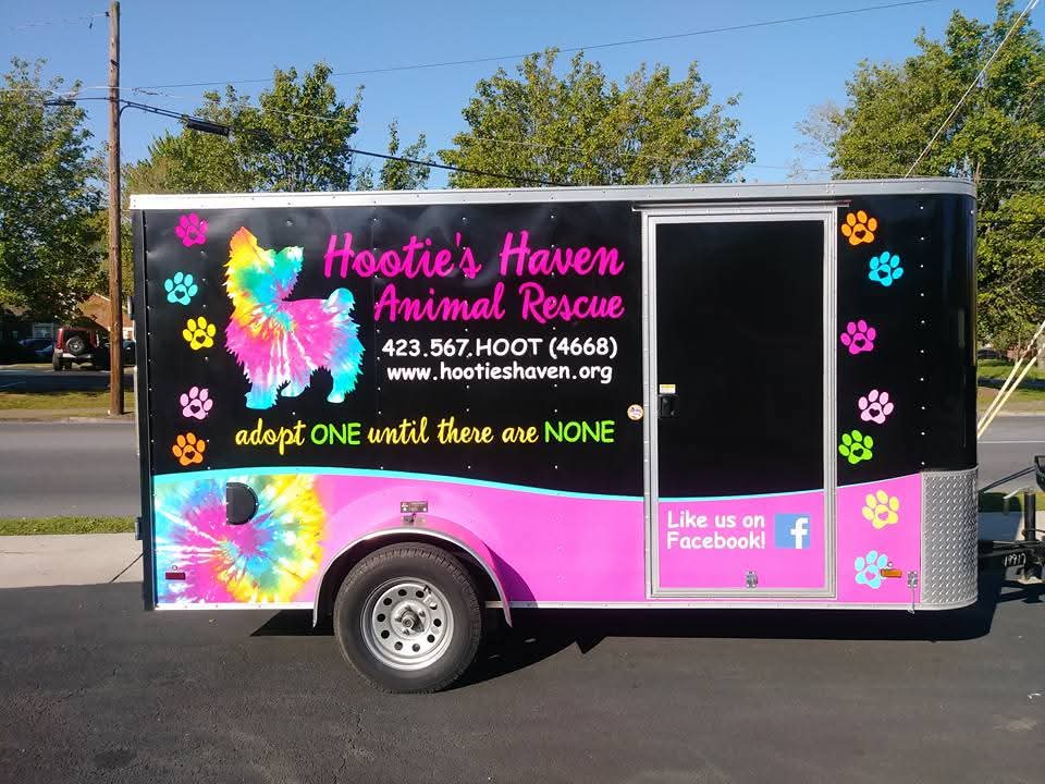 Black and pink trailer wrap with tie-dye dog graphic for Hootie's Haven Animal Rescue