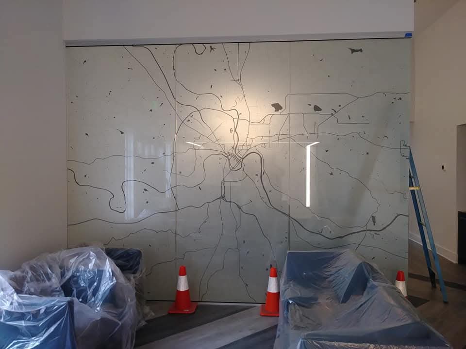 Frosted glass wall with a cut vinyl city map design in a new office build