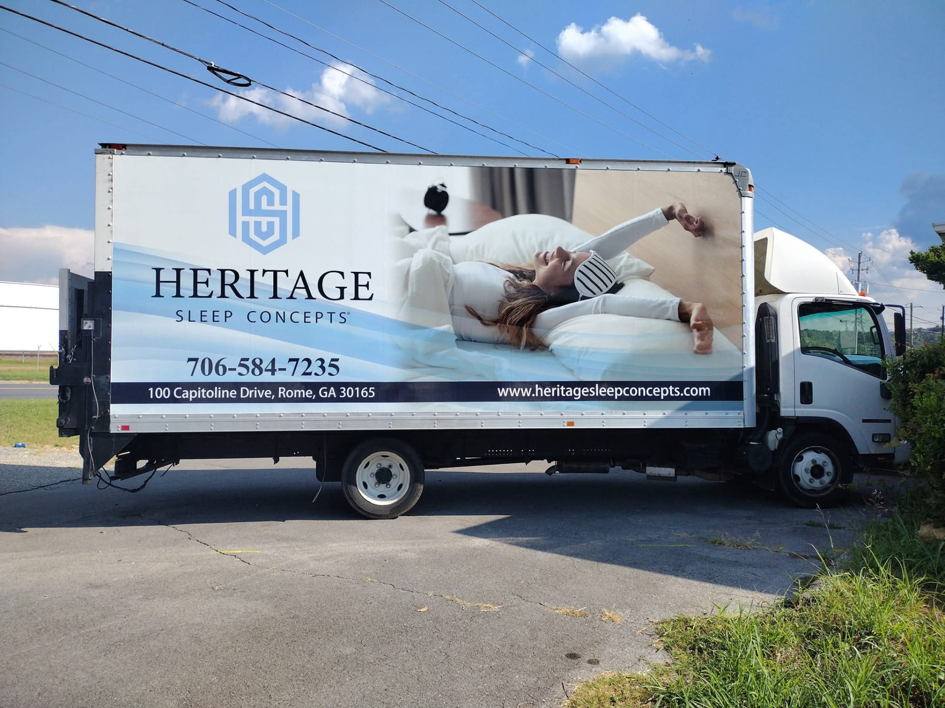 White box truck wrapped with Heritage Sleep Concepts branding and a lifestyle photo