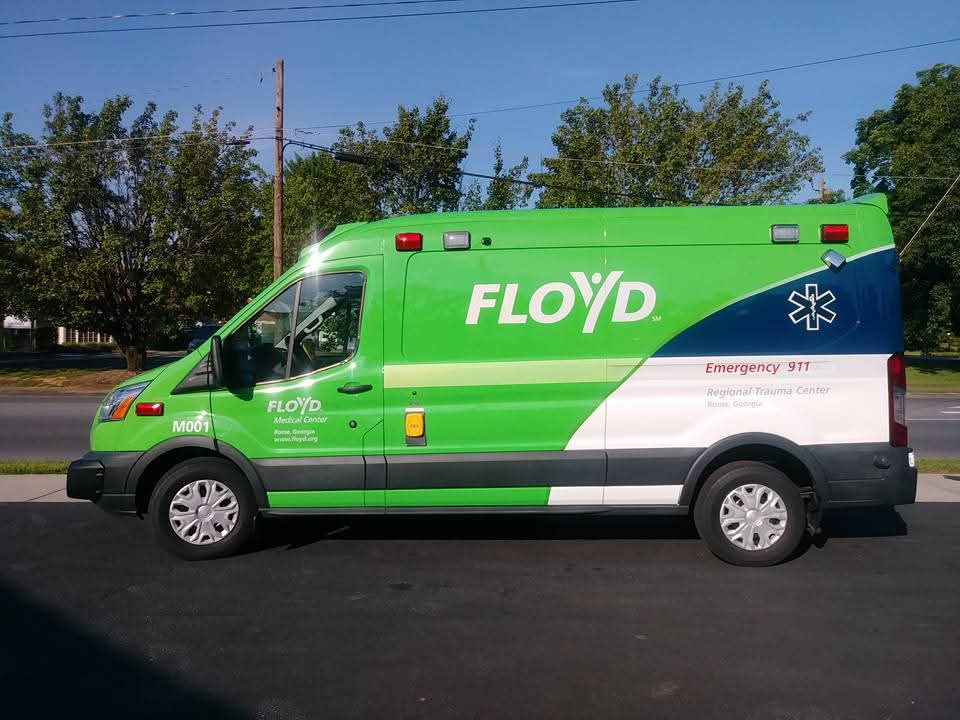Green Floyd Medical Center transit ambulance van with matching fleet graphics