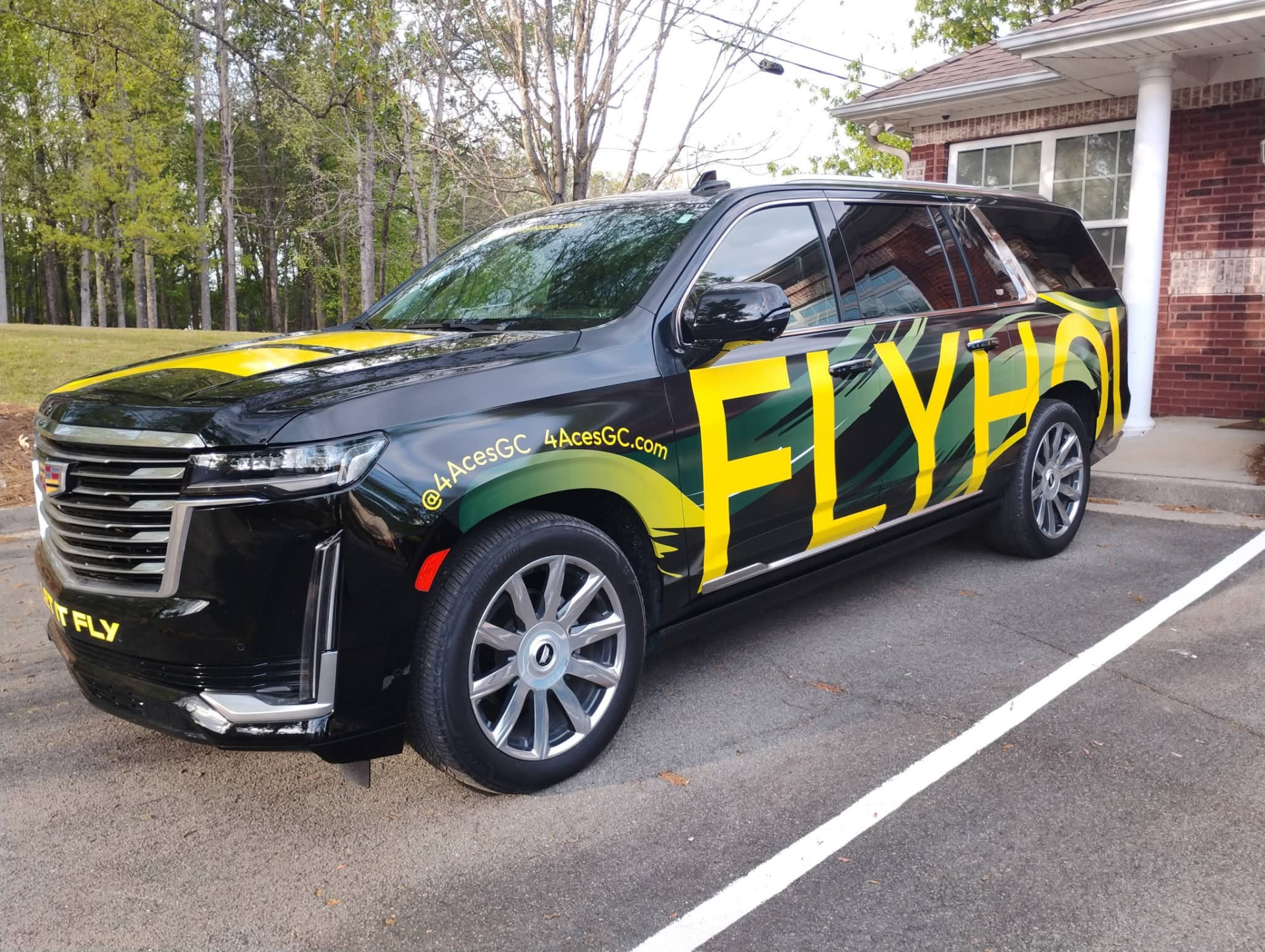 Black Cadillac Escalade wrapped with Flyhouse Aviation graphics at Augusta Nationals