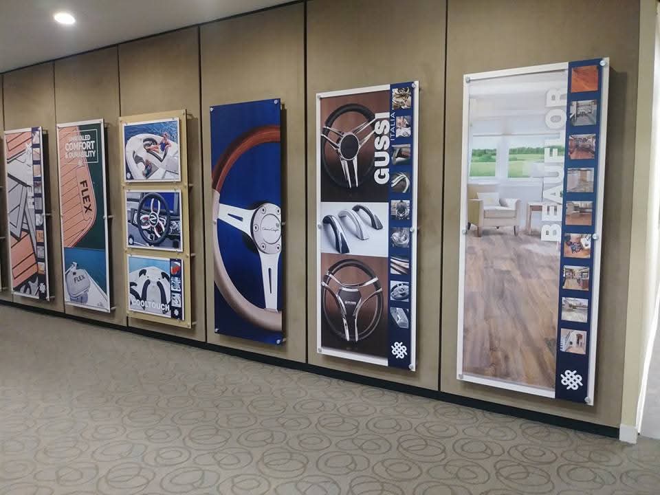 Office hallway wall covered with tall vertical product and lifestyle display banners