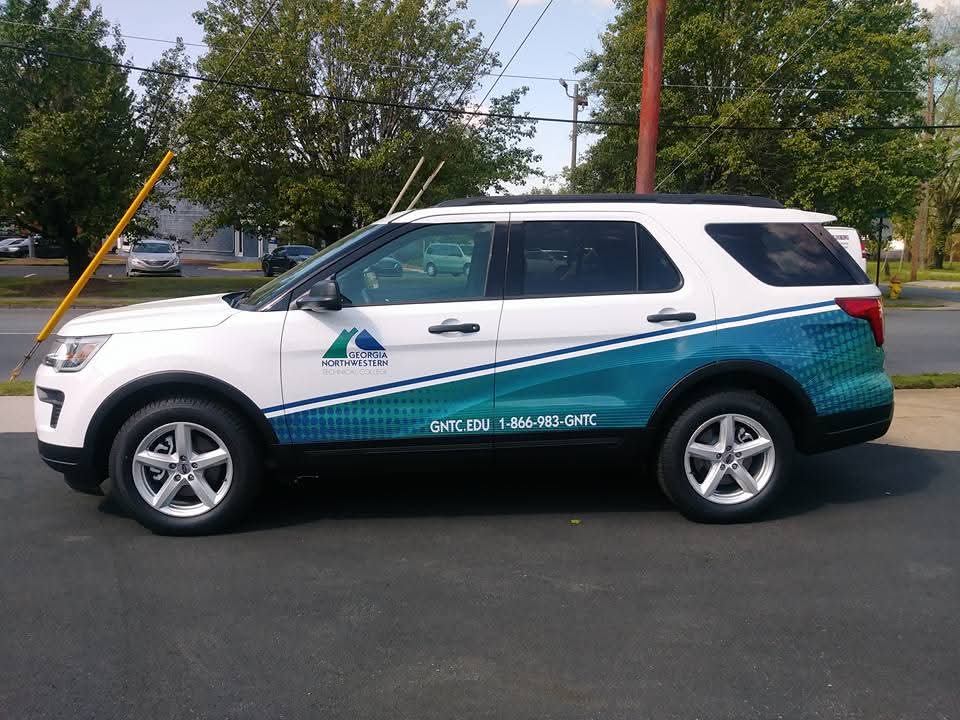 White Ford Explorer with Georgia Northwestern Technical College partial wrap