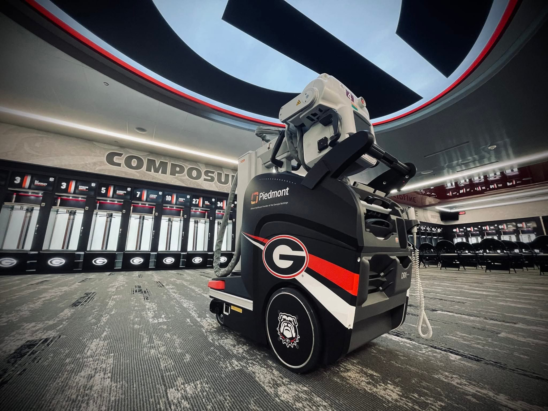 Mobile medical imaging cart wrapped in Georgia Bulldogs and Piedmont branding inside a locker room
