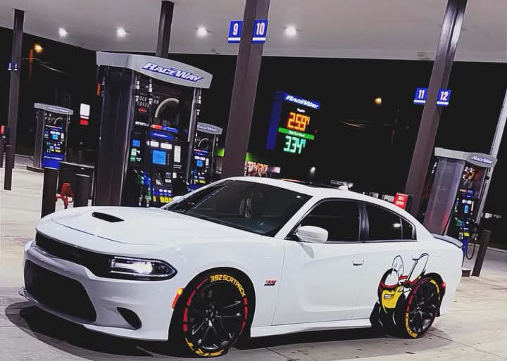 White Dodge Charger Scat Pack with custom character graphic on the rear quarter panel and printed wheel lettering