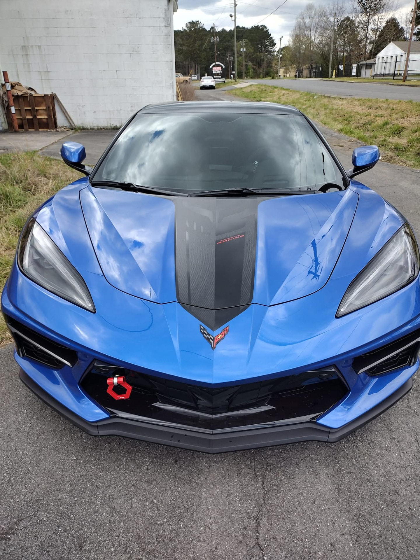 Blue C8 Corvette with a satin black center hood stripe